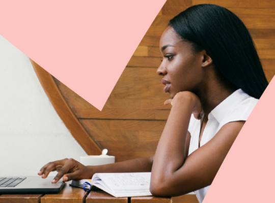 A woman is working on a laptop.