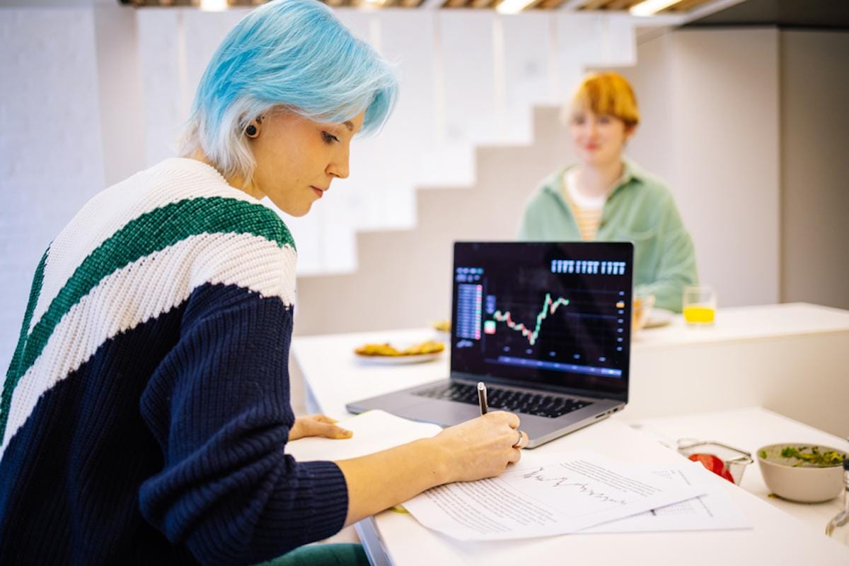 Person looking over stock reports on a screen